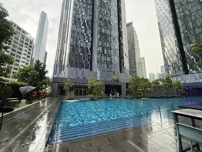 a large swimming pool in a city with tall buildings at Star Residance KLCC by Nexus 13 in Kuala Lumpur