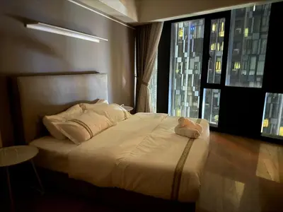 a bedroom with a large white bed with a window at Star Residance KLCC by Nexus 13 in Kuala Lumpur