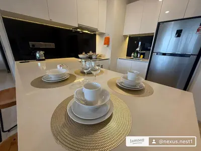 a kitchen with a table with cups and saucers on it at Star Residance KLCC by Nexus 13 in Kuala Lumpur
