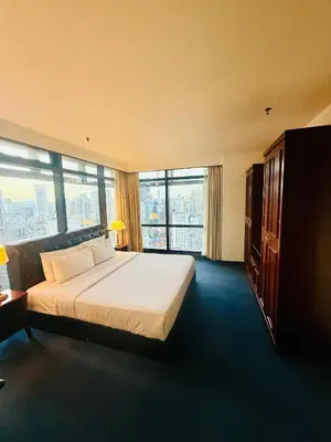 a hotel room with a bed and a large window at Times Square Kuala Lumpur by Willow Trip in Kuala Lumpur