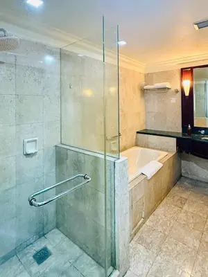 a bathroom with a shower and a bath tub at Times Square Kuala Lumpur by Willow Trip in Kuala Lumpur