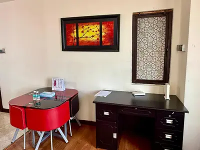 a room with a desk and red chairs and a window at Times Square Kuala Lumpur by Willow Trip in Kuala Lumpur