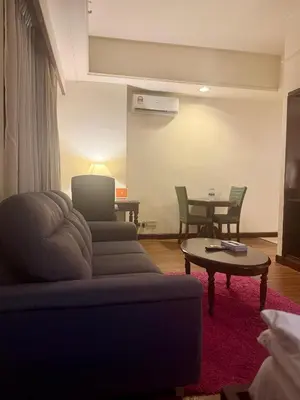 a living room with a couch and a table at Times Square Kuala Lumpur by Willow Trip in Kuala Lumpur