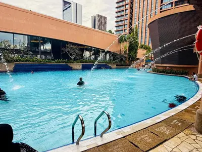 a large swimming pool with a person in the water at Times Square Kuala Lumpur by Willow Trip in Kuala Lumpur