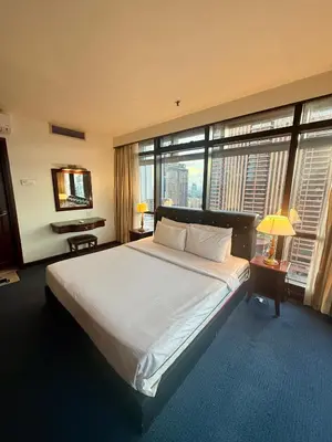 a bedroom with a large bed and large windows at Times Square Kuala Lumpur by Willow Trip in Kuala Lumpur