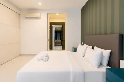 a bedroom with a large white bed with white pillows at The Platinum Kuala Lumpur by MAHA in Kuala Lumpur