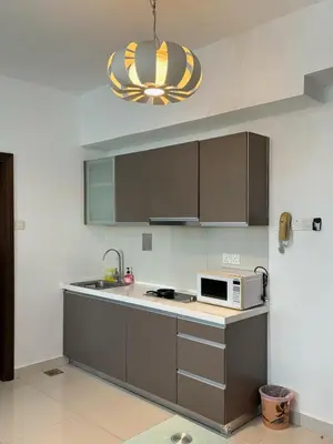 a kitchen with a sink and a microwave at The regalia KLCC panorama view in Kuala Lumpur