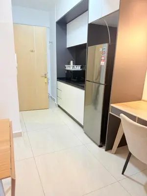 a kitchen with a stainless steel refrigerator and a table at Colony Suites KL by Sopping Centre in Kuala Lumpur