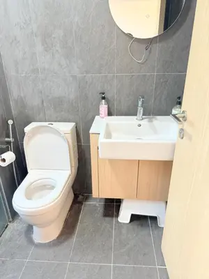 a bathroom with a toilet and a sink at Colony Suites KL by Sopping Centre in Kuala Lumpur