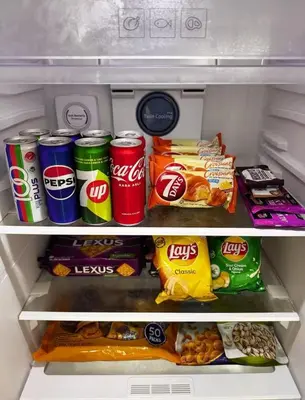 an open refrigerator filled with food and drinks at luxury One Bedroom KLCC in Kuala Lumpur