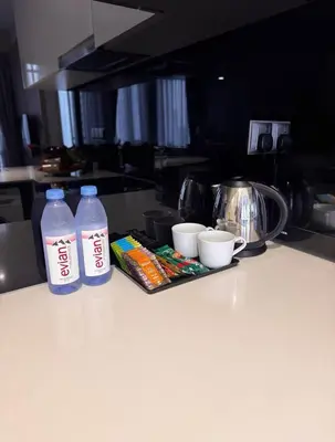 two bottles of water and snacks on a kitchen counter at luxury One Bedroom KLCC in Kuala Lumpur