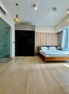 a bedroom with a large bed and a wooden floor at luxury One Bedroom KLCC in Kuala Lumpur