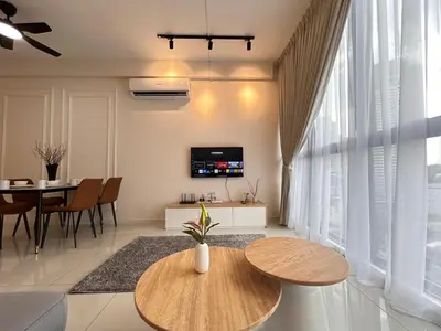 a living room with two wooden tables and a tv at Majestic Residence by Manhattan Group in Kuala Lumpur