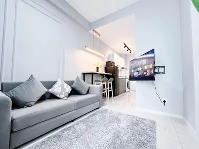 a living room with a couch and a tv at Majestic Residence by Manhattan Group in Kuala Lumpur