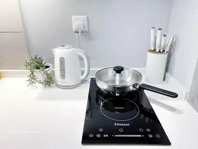 a kitchen stove with a pot on top of it at Majestic Residence by Manhattan Group in Kuala Lumpur