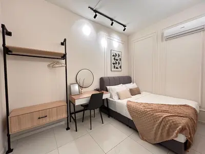 a bedroom with a bed and a desk with a bed and a chair at Majestic Residence by Manhattan Group in Kuala Lumpur
