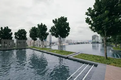 a swimming pool with trees and a city in the background at Cozy Home to explore KL City KLCC TRX Bkt Bintang in Kuala Lumpur