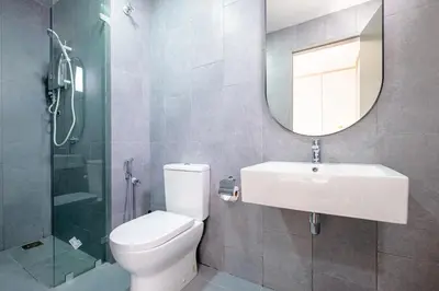 a bathroom with a toilet and a sink and a mirror at Cozy Home to explore KL City KLCC TRX Bkt Bintang in Kuala Lumpur