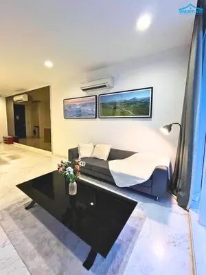 a room with a bed and a table with flowers on it at Platinum Suites KLCC by Dream'Inn in Kuala Lumpur