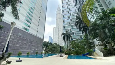 a pool in the middle of a city with tall buildings at 3-10mins to klcc -pavilion -premium studio 2-4pax in Kuala Lumpur