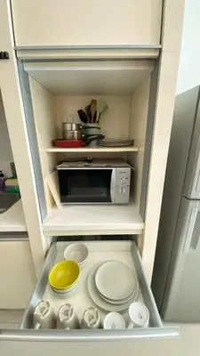 a kitchen with a microwave and some plates and bowls at 3-10mins to klcc -pavilion -premium studio 2-4pax in Kuala Lumpur