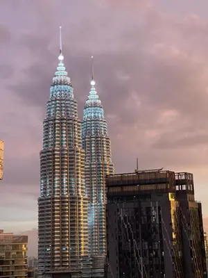 two tall skyscrapers in a city with buildings at Royce Residence KLCC by ABM Unique in Kuala Lumpur