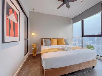 a bedroom with a bed and a ceiling fan at The Platinum Galaxy Suites KLCC in Kuala Lumpur