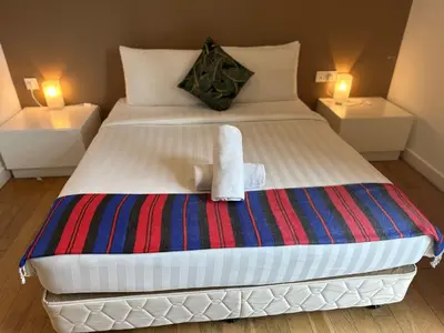 a bedroom with a bed with a towel on it at The Platinum Galaxy Suites KLCC in Kuala Lumpur