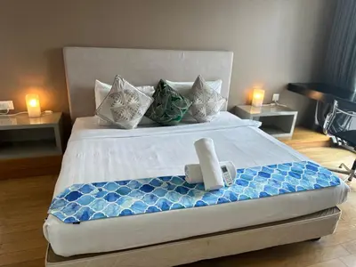 a bedroom with a large bed with a blue and white bedspread at The Platinum Galaxy Suites KLCC in Kuala Lumpur