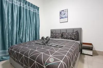 a bedroom with a bed with a gray comforter at Chan Sow Lin - Cozy 3B3B - 6 pax - F&B & Mart in Kuala Lumpur
