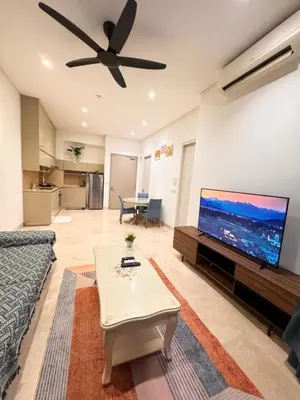 a living room with a couch and a flat screen tv at Lucentia Suties Rooftop pool by Lalaport KL in Kuala Lumpur