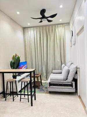 a living room with a ceiling fan and a couch at Lucentia Suties Rooftop pool by Lalaport KL in Kuala Lumpur