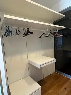 a white refrigerator with shelves and hangers at Global Suites at Platinum kLCC in Kuala Lumpur