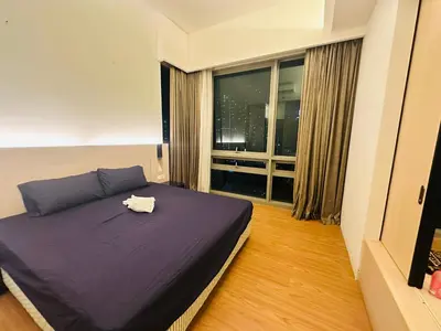 a bedroom with a purple bed and a window at Swiss Garden Resident By FA in Kuala Lumpur