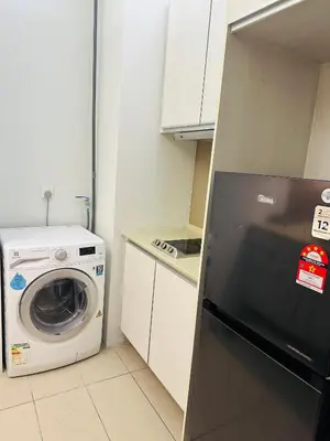 a kitchen with a washing machine and a washer at Swiss Garden Resident By FA in Kuala Lumpur