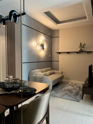 a living room with a table and a dining room at Dorsett Hartamas - Luxury Studio with Bathtub in Kuala Lumpur