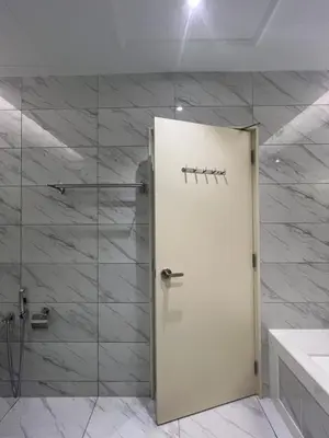 a bathroom with a shower with a white door at Dorsett Hartamas - Luxury Studio with Bathtub in Kuala Lumpur