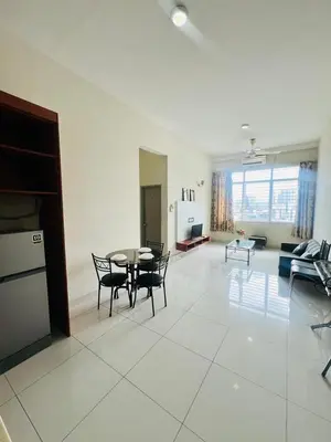 a large living room with a table and chairs at KLCC View Apartment in Kuala Lumpur