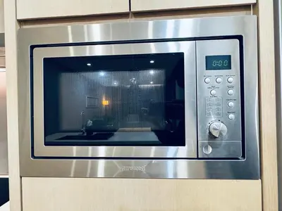 a microwave oven with a window in a kitchen at 188 suites Apartment with KLCC View by Vho'Z in Kuala Lumpur