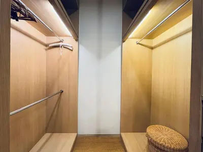 a walk in shower with a wicker stool in a room at 188 suites Apartment with KLCC View by Vho'Z in Kuala Lumpur