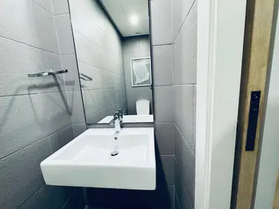 a bathroom with a white sink and a mirror at 188 suites Apartment with KLCC View by Vho'Z in Kuala Lumpur