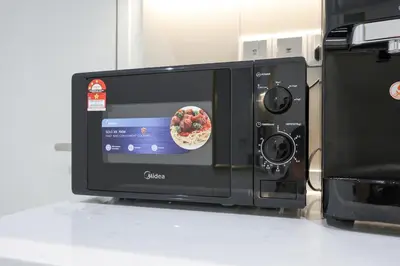 a black microwave with a bowl of food inside at Majestic Residence near KLCC Quill City 1 in Kuala Lumpur