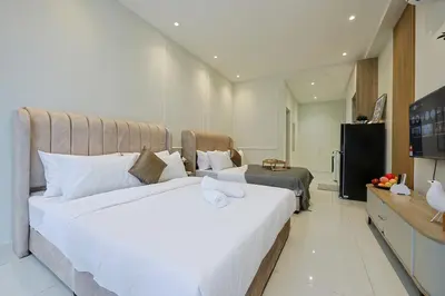 a bedroom with a large white bed and a television at Majestic Residence near KLCC Quill City 1 in Kuala Lumpur