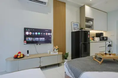a kitchen with a refrigerator and a table with fruit on it at Majestic Residence near KLCC Quill City 2 in Kuala Lumpur