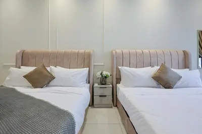 two beds sitting next to each other in a bedroom at Majestic Residence near KLCC Quill City 2 in Kuala Lumpur