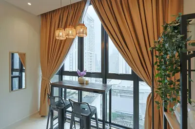 a dining room with a table and chairs in front of a window at Majestic Residence near KLCC Quill City 2 in Kuala Lumpur