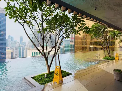 a swimming pool with a tree on top of a building at Akson Residensi Axon Bukit Bintang by TaheeenS in Kuala Lumpur
