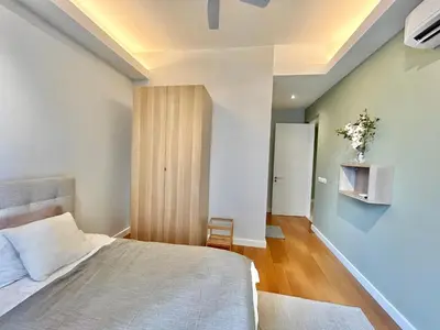 a bedroom with a bed and a blue wall at KL Sentral 16th Floor KL City View in Kuala Lumpur