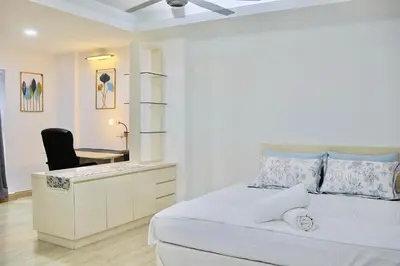 a white bedroom with a desk and a bed at 3BR at Holiday Place Kuala Lumpur 5 mins to KLCC & MRT in Kuala Lumpur