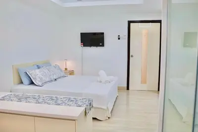 a white bedroom with a bed and a tv at 3BR at Holiday Place Kuala Lumpur 5 mins to KLCC & MRT in Kuala Lumpur